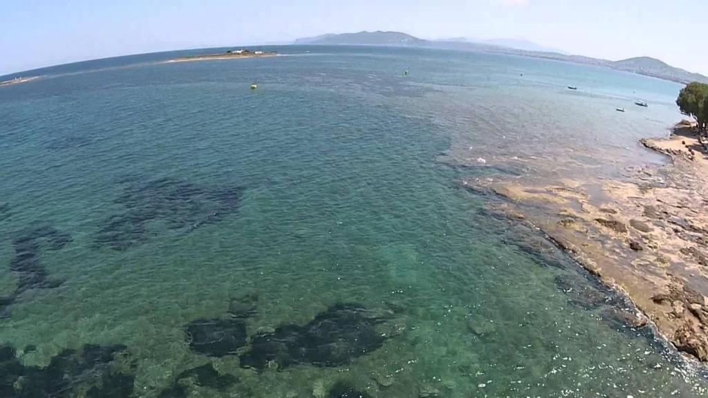 Aerial view of crystal-clear sea at Nissakia Beach, Artemida, Greece
