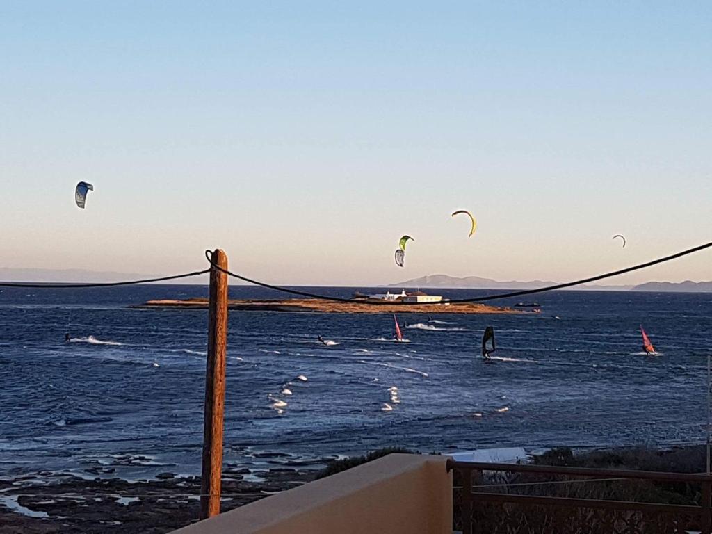 Kitesurfers at sunset off the beach in Artemida, Attica